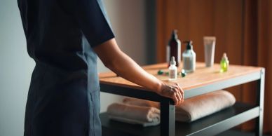 Person standing near a cart with spa products.