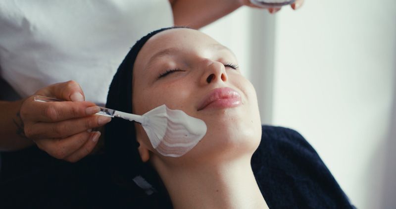 Beautiful young woman taking facial massage in spa. Concept for skin care, anti aging, and wellbeing.