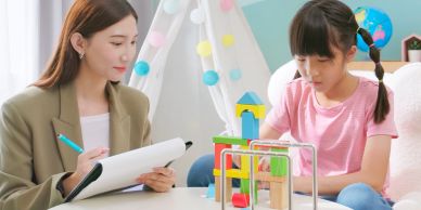 Therapist assessing a child with building blocks.