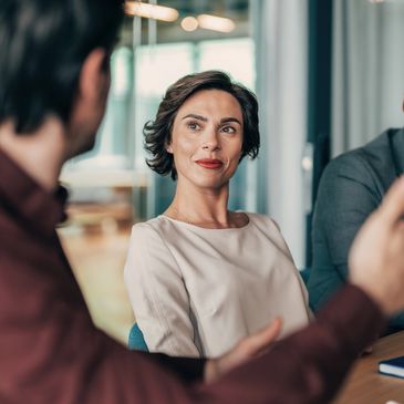 Woman attentively listening in a discussion.