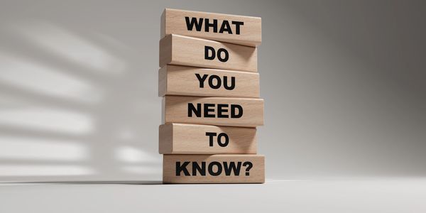 Stacked wooden blocks ask, 'What do you need to know?'.