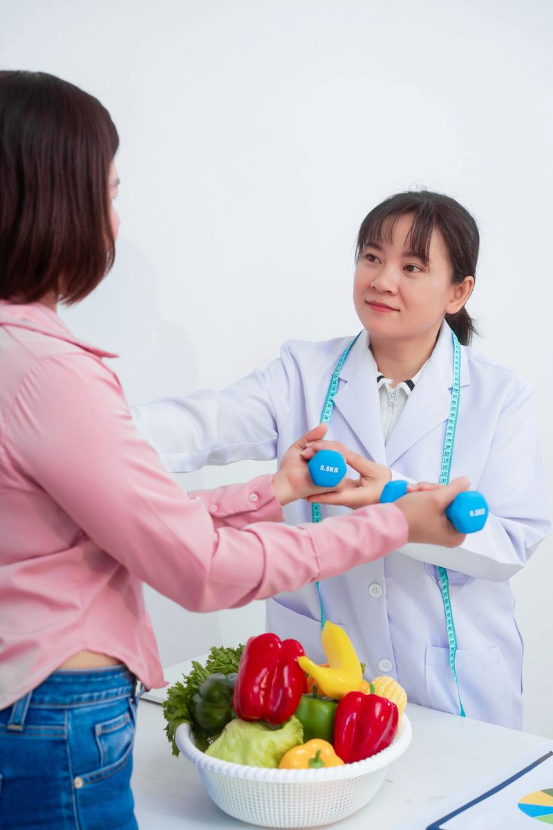 A middle aged Asian female nutritionist consults with a middle aged Asian female patient at a table, discussing nutrition, healthy eating, exercise, and lifestyle changes for weight loss and health