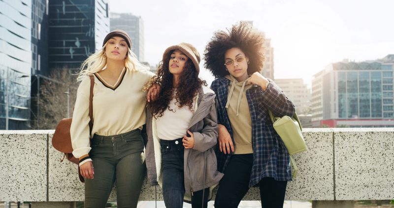 Portrait, people and friends for fashion in city with streetwear, edgy clothes and trendy style. Confident, women and gen z with support, swag and urban outfit with accessories for bonding together