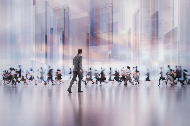 Businessman walking in futuristic city. 3D generated image.
