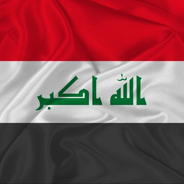 Flag of Iraq with red, white, and black stripes and Arabic script.