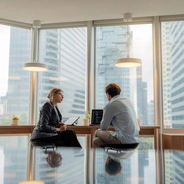 Two professionals discussing work in a modern office.