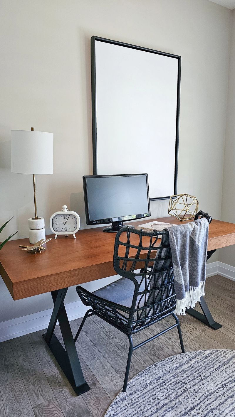 Contemporary mockup workspace showcases a wooden desk with a computer, decorative lamp, and cozy accessories, creating an inviting environment for work