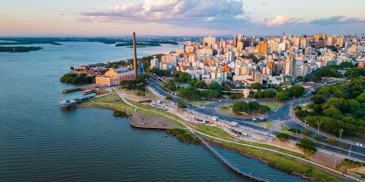 Aerial view of a city by the river at sunset.