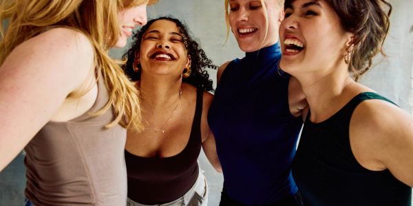 Four women laughing and enjoying each other's company.