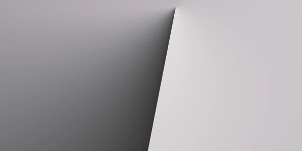 Abstract image of a sharp shadow on a light gray surface.