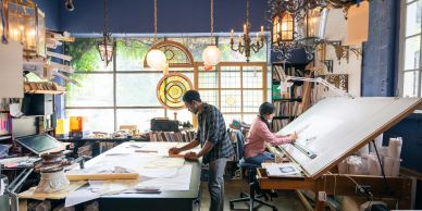 Two architects working in a bright studio.