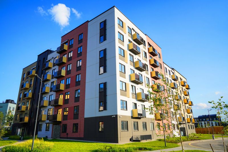 Modern apartment building residential complex. British residential complex. Apartment complex uk. Urban housing. Residential complex in british style exterior. Entrance in Residential block house.