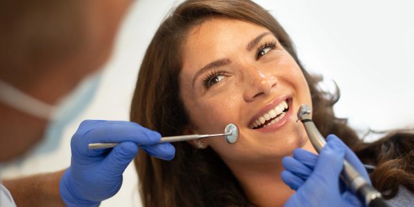 Woman smiling during a dental checkup.