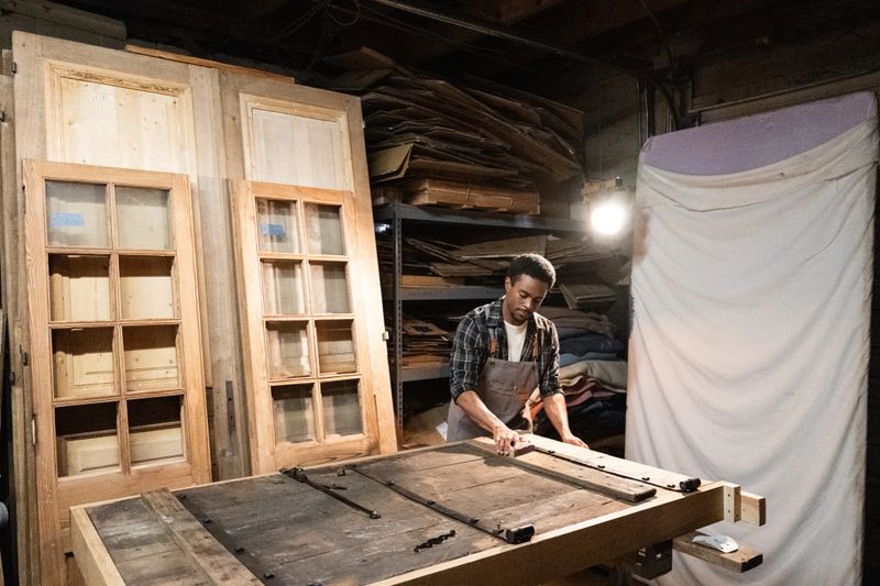 Carpenter restoring and old door in the workshop