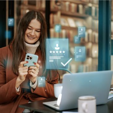 Smiling woman using phone with digital rating icons in a cozy setting.