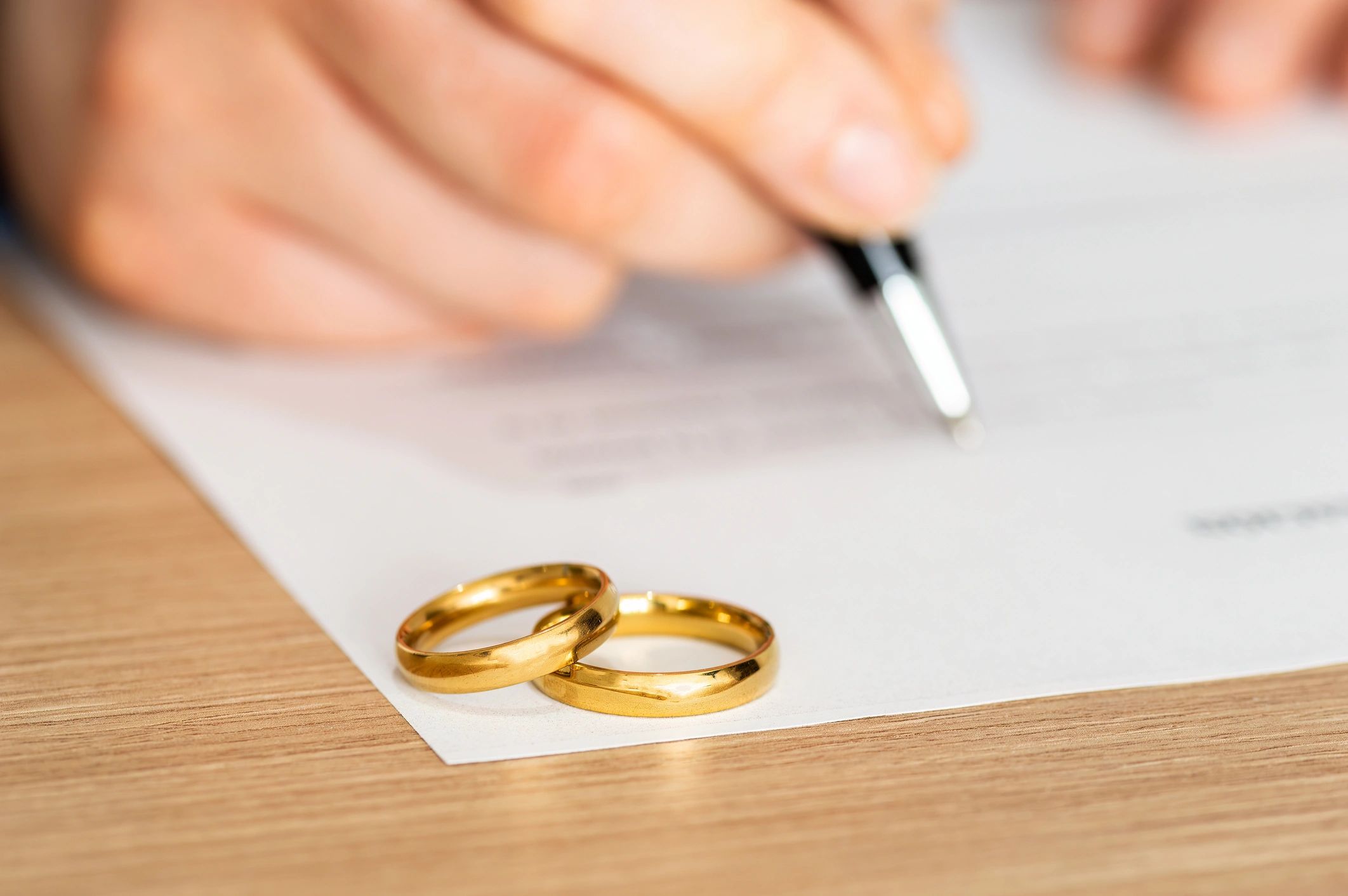 gold bands on a wedding license about to be signed