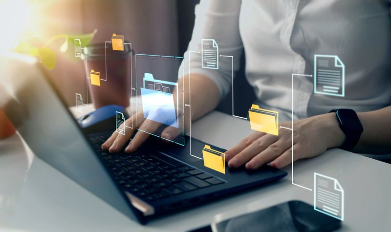 Online documentation database and document management system concept. Businesswoman working on laptop with virtual screen. Process automation to efficiently manage files