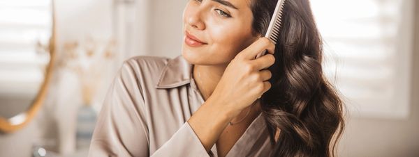 Hair care products from Formula 18 on soil with plants.