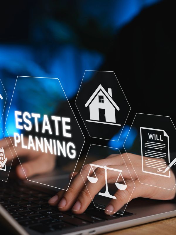 Hands typing on a laptop with estate planning icons overlay.