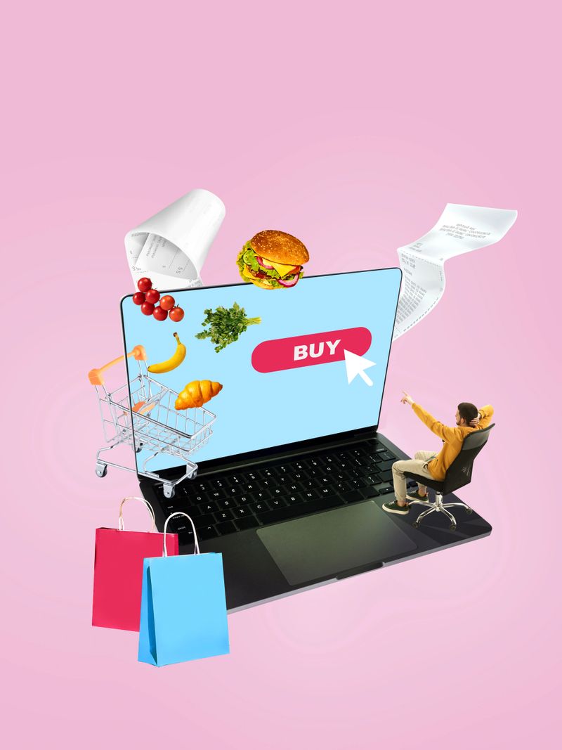 Creative collage. Businessman with laptop surrounded by floating shopping carts and colorful bags. Concept of e-commerce, advertising design, groceries delivery promotions, and mobile shopping.