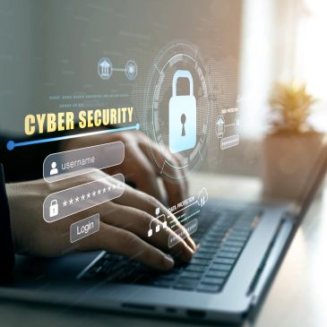 Hands typing on a laptop with cybersecurity login interface.