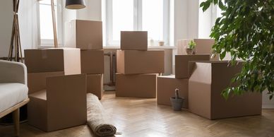 Cardboard boxes packed in a room ready for moving.