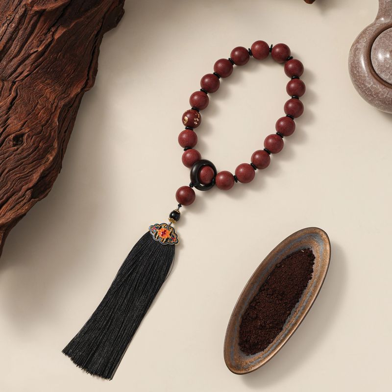 A wooden bead bracelet laid flat, showcasing natural materials and craftsmanship,is an accessory that can be worn on the wrist or ankle