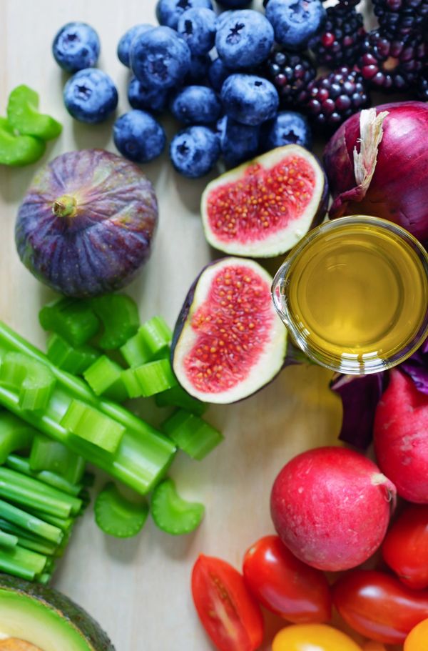 Fresh fruits and vegetables with a glass of juice.