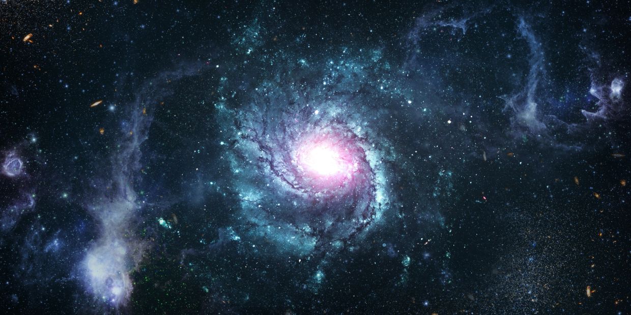 A vibrant spiral galaxy glowing brightly in deep space.
