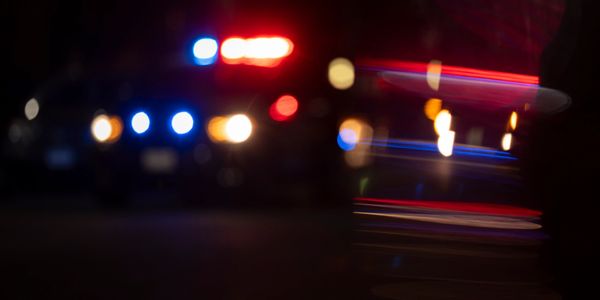 Blurred police car lights flashing at night.