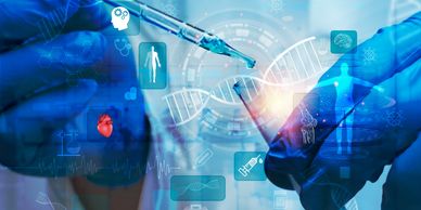 Gloved hands holding lab beaker and pipet.