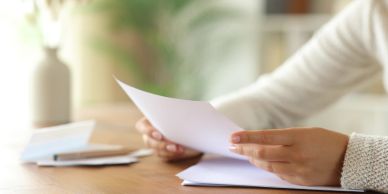 Person reading a document at a desk.