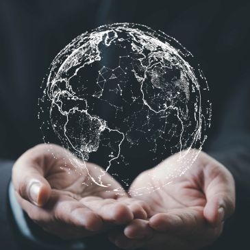 Hands holding a digital globe representation.