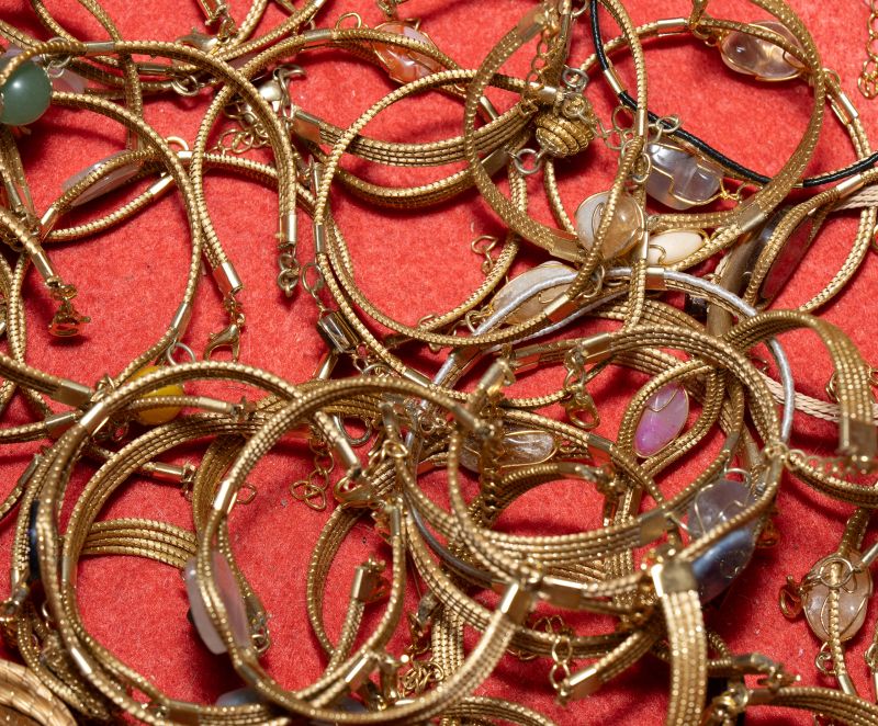 Set of handmade bracelets crafted from Brazilian golden grass with natural stones. Eco-friendly artisan jewelry combining golden fiber and semi-precious gems. Unique boho fashion accessories.