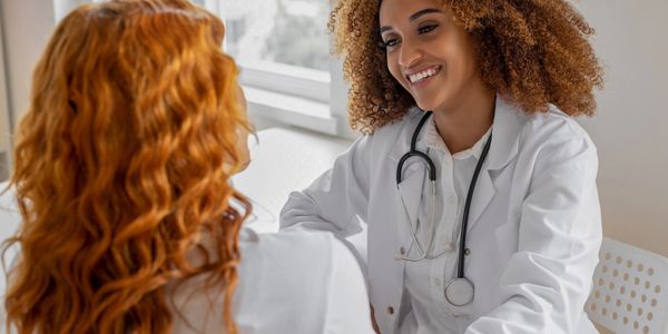 Doctor smiling and talking to a patient.