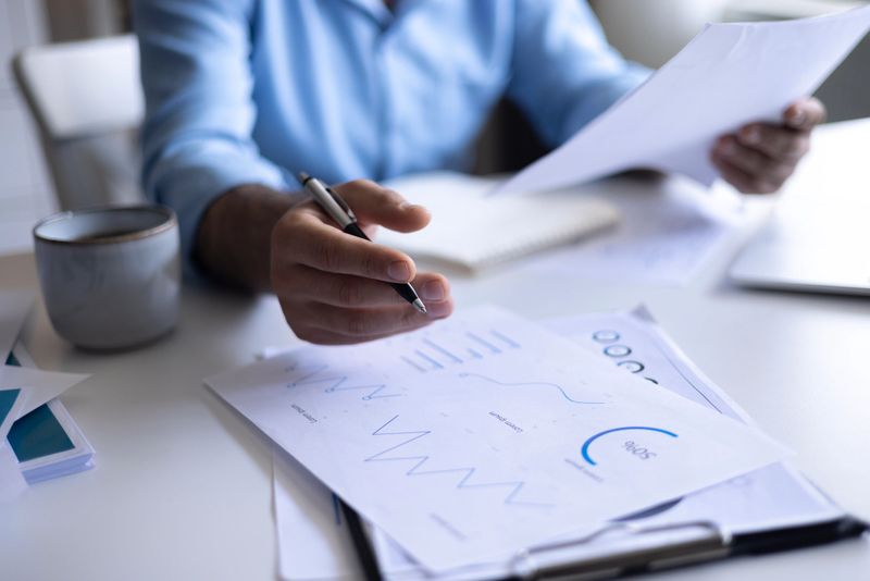 Businessman working on Financial Report of corporate operations, balance