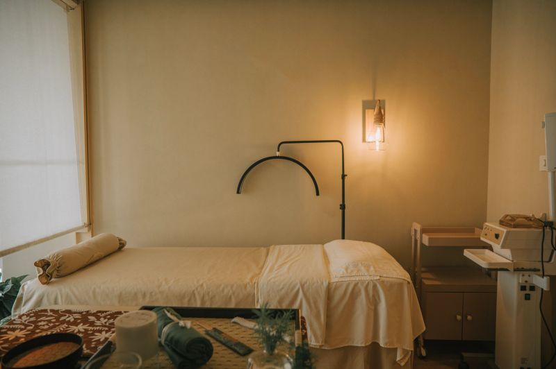 Serene spa treatment room prepared with a bed and soft lighting, creating a peaceful and welcoming atmosphere for relaxation and wellness Bangkok