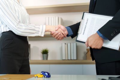 Two business professionals shaking hands, sealing a deal.
