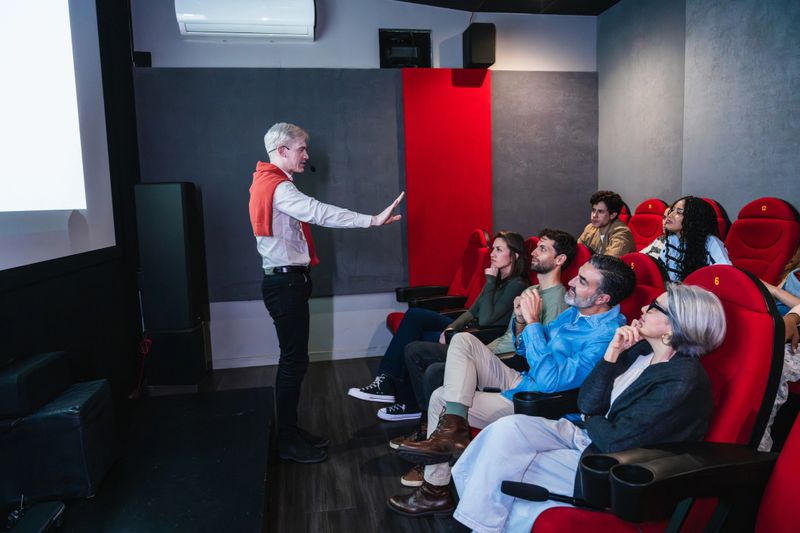 Engaging speaker delivers a compelling presentation to a diverse audience in a modern conference room, fostering collaboration and knowledge sharing