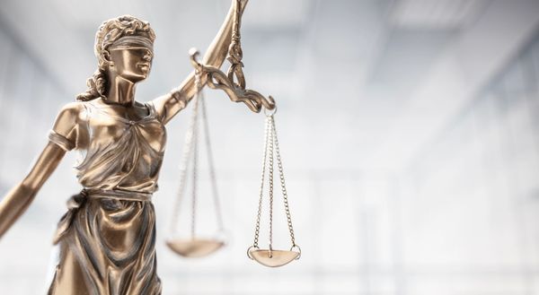 Statue of blindfolded Lady Justice holding scales.