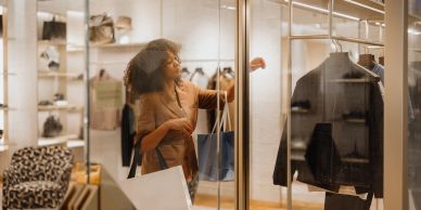 Woman shopping and looking at clothes in a store.