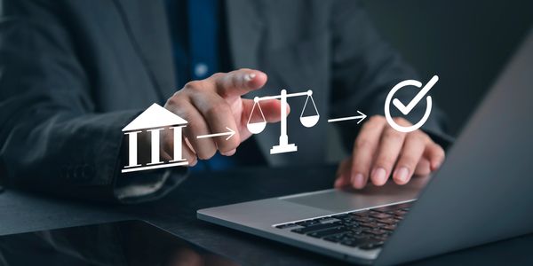 Businessman interacting with justice and approval icons on laptop.
