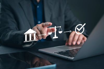 Businessman operating legal process icons on laptop.
