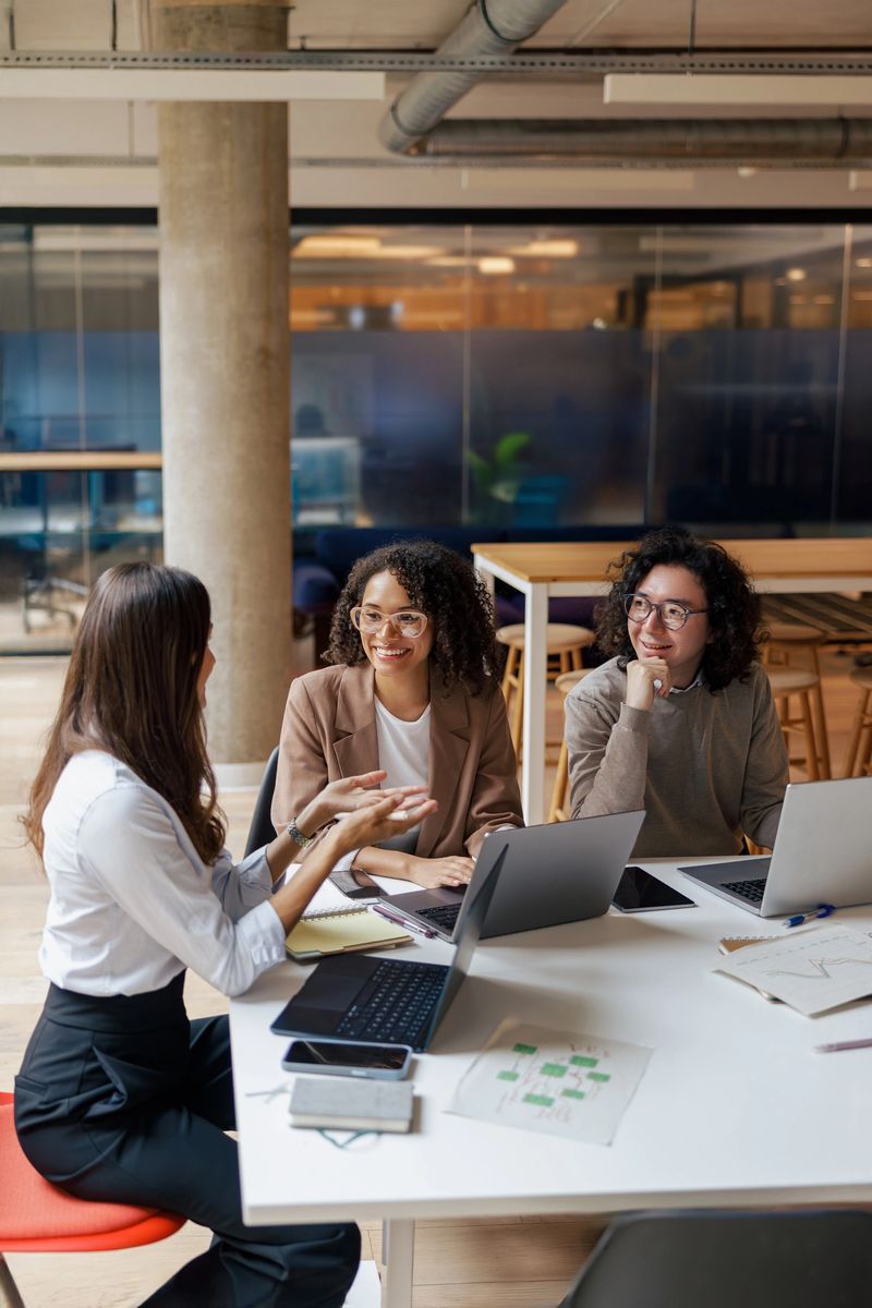 Team members enthusiastically engaged in a highly productive brainstorming session within a contemporary workplace