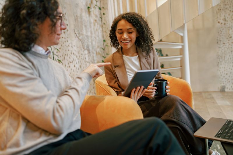 Two professionals are engaged in a dynamic discussion about innovative ideas in a contemporary office setting