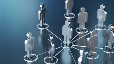 Metallic human figures interconnected, symbolizing networking or team collaboration.