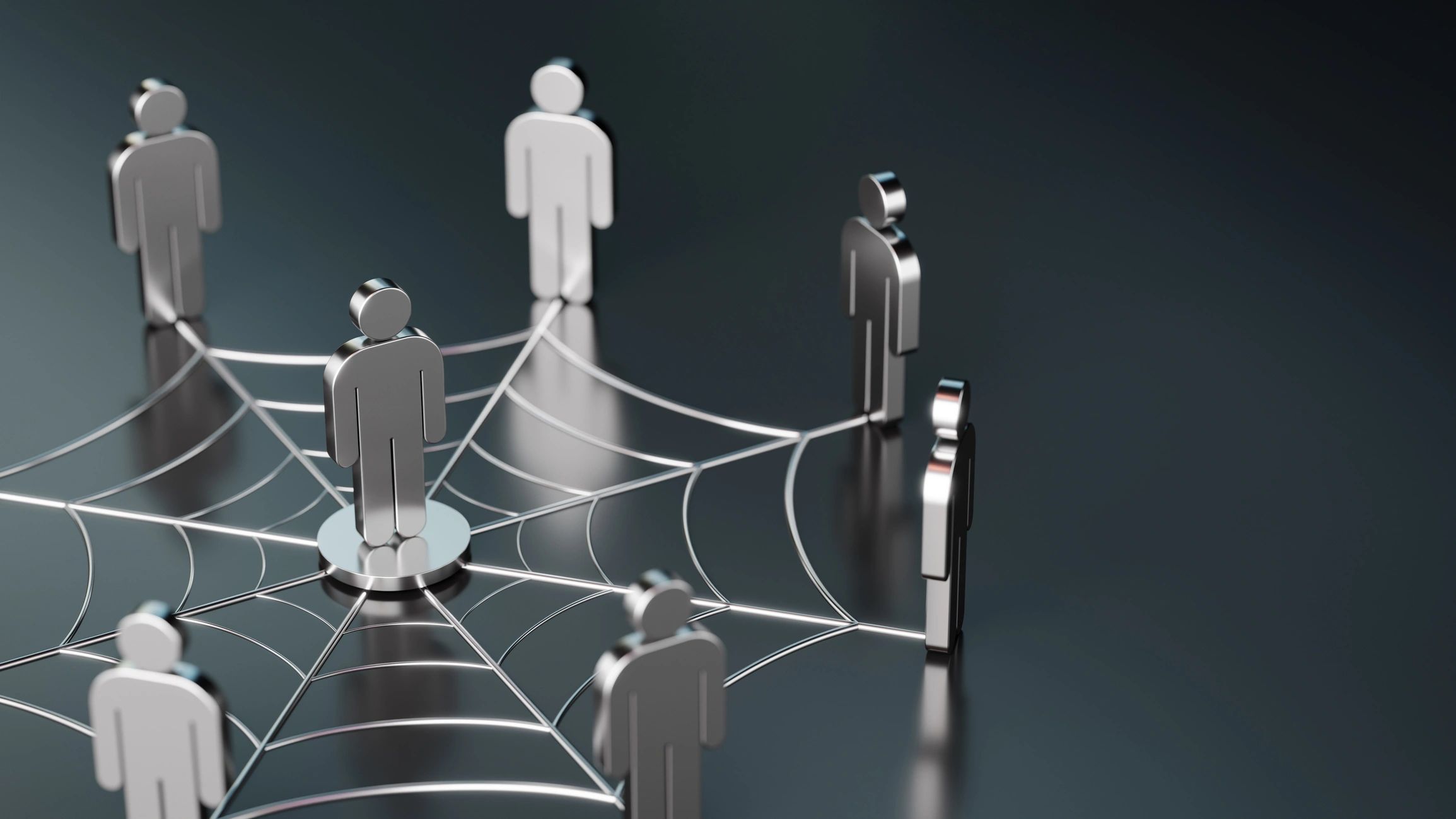Metal figures connected by a web, symbolizing network or social connection.
