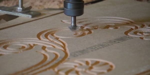 CNC machine carving intricate patterns into wood.