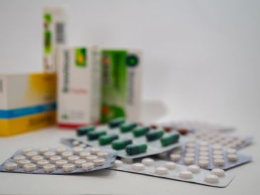 Various blister packs of pills and medication boxes.
