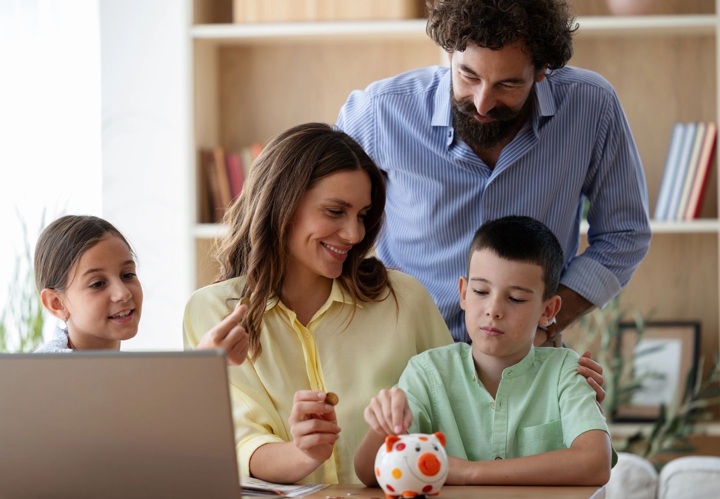 Stack of books next to pencils in a holder and a camera.